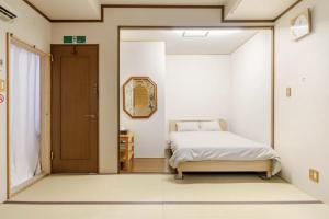 a small bedroom with a bed and a sliding door at Foresta Karuizawa 2 in Oiwake
