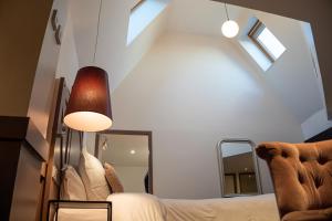 a bedroom with a bed and a mirror in a room at La Maison des Armateurs in Saint Malo +70 photos