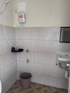 a bathroom with a toilet and a sink at Baden Powell Hostel in Baguio +48 photos