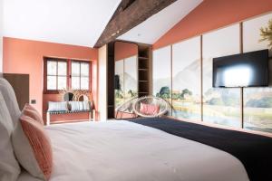 a bedroom with a large bed and a flat screen tv at CENTRAL Hôtel Bordeaux Centre in Bordeaux