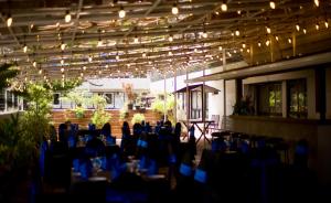 a room with blue tables and chairs and lights at Hotel Sapphire in Colombo