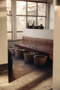 a row of sinks in a bathroom with windows at Varbergs Kusthotell in Varberg +97 photos