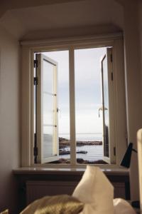 a bedroom with a window with a view of the ocean at Varbergs Kusthotell in Varberg