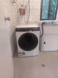 a washer and dryer sitting in a room at Stay Breezy in Erowal Bay +54 photos