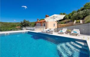 una piscina con due sedie e un ombrellone di Villa Lucija Dream a Trgetari