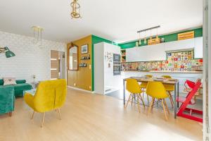 a kitchen and dining room with yellow chairs and a table at La Casita Mexicana - Kids Friendly by So Homy- 3 Bed Room - 6 PAX in Saint-Ouen +26 photos