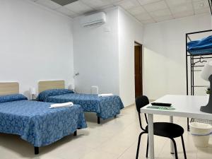 Postel nebo postele na pokoji v ubytování Hostal Kaizen