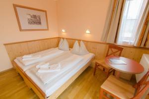 Rúm í herbergi á JUFA Hotel Gitschtal