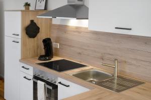 a kitchen with a sink and a stove at Meerrettichnest in Appenweier +10 photos