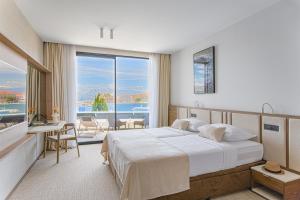 a bedroom with a large bed and a large window at Grand Hotel View in Postira