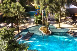 an overhead view of a swimming pool with chairs and a slide at Hotel Saint George in Puerto Iguazú