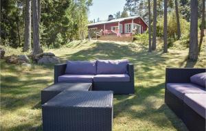 two couches and a table in front of a house at Cozy Home In Djurhamn With Wifi in Djurhamn