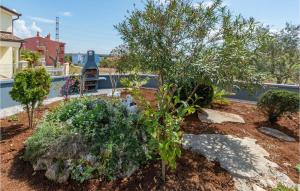 a garden with trees and plants in a yard at Apartment Betiga With Sea View 02 in Barbariga