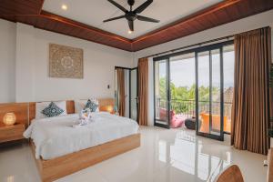 a bedroom with a bed and a large window at Grand opening sale, Canggu, Villa Serenity Haven in Canggu +42 photos