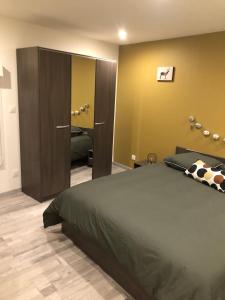 a bedroom with a large bed and a closet at La Ruine Single-family House with Hot Tub in Laveline