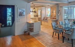 a kitchen and dining room with a table and chairs at Lovely Home In Uddevalla With Kitchen in Uddevalla
