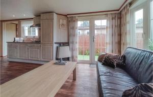 a living room with a couch and a table at Nice Home In Heinkenszand With Wifi in Heinkensand