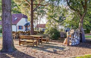 a park with benches and a table and trees at Beautiful Home In Fuhlendorf With Wifi in Fuhlendorf