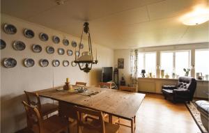 a living room with a wooden table and chairs at Beautiful Home In Ed With Kitchen in Ed