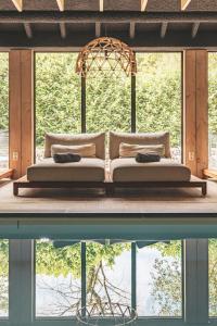 a bed sitting on a platform next to a body of water at Hotel de Sterrenberg - Adults Only in Otterlo