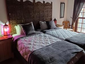 two beds sitting next to each other in a bedroom at Wooden Creek Estate in Kempton Park