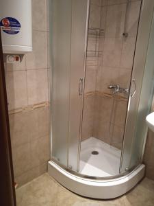 a shower with a glass door in a bathroom at Nessebar, Studio,South Beach, Larisa in Nesebar +23 photos