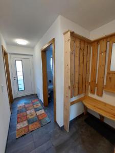 a room with wooden walls and a hallway with a bench at Ferienwohnung Gstreinthaler in Tulfes +61 photos