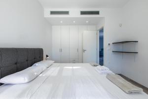 a large white bed with two pillows on it at Sage Villa by Vintage Travel in Tavronitis +20 photos