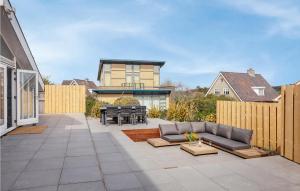 a patio with a couch and a table at Villa By The Sea in Bergen aan Zee