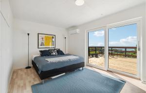 a bedroom with a bed and a large window at Gorgeous Home In Hasle in Hasle