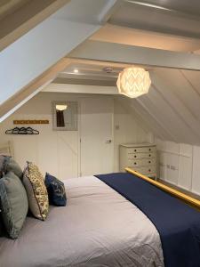 a bedroom with a large bed in the attic at Trowel and Hammer, Flat 2 in Cotton +7 photos