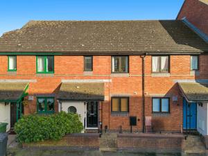 a red brick house with a black roof at Quay Retreat - Short Stays UK Ltd in Exeter