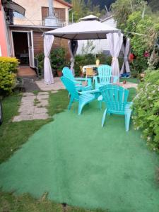 - une table et des chaises sous un parasol dans la cour dans l'établissement Chez Françoise, à Cilaos