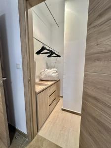 a walk in closet with a wooden cabinet at Colcha Suites in Granada