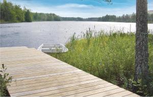 a boat sitting on the side of a wooden dock at Amazing Home In Tingsryd With Wifi in Ryd