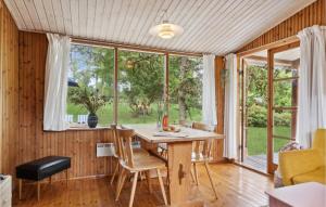 a dining room with a table and chairs in front of a window at Nice Home In Nykøbing Sj With Wifi in Klint
