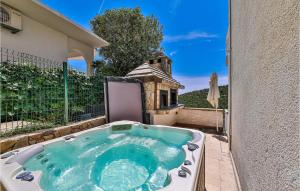 a hot tub on the back of a building at Gorgeous Home In Vinisce With Jacuzzi in Vinišće +32 photos