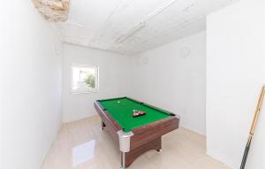 a pool table in a room with white walls at Gorgeous Home In Vinisce With Jacuzzi in Vinišće