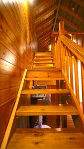 an overhead view of a wooden staircase in a cabin at Ye Jiang Hua Homestay in Meishan