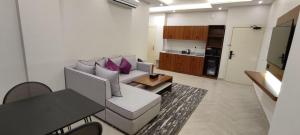 a living room with a couch and a table at أصالة الشروق حائل in Hail