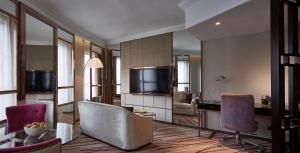 a living room with a television and a table and chairs at Dorsett Wanchai, Hong Kong in Hong Kong