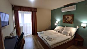 Posteľ alebo postele v izbe v ubytovaní Átrium Hotel Harkány