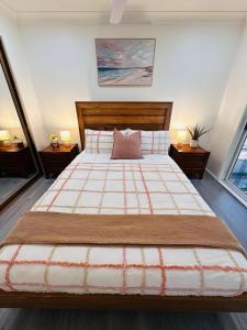 a bedroom with a large bed and two windows at The Urban Cozy Cottage - 5 Mins to Parramatta or Westmead Hospital or WSU in Wentworthville