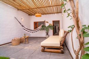 a patio with a hammock and a chair and a table at Prea Zen in Prea