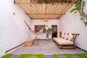 a patio with a hammock and a chair at Prea Zen in Prea +24 photos