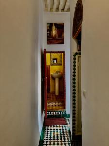 a hallway with a bathroom with a sink and a mirror at Appartement khmissa in Fès al Bali +102 photos