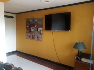 a flat screen tv hanging on a wall at Finca Turistica VillaMaria in Tena