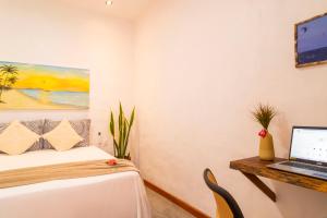 a bedroom with a bed and a laptop on a desk at Suite Sol Preazen in Prea