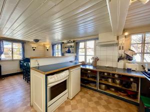 a kitchen with a stove and a counter top at 300 years old Chalet close to Center ski-lift in Chateau-d'Oex