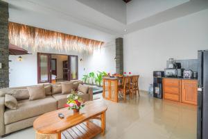 a living room with a couch and a table at Villa Bella Wilson III in Seminyak